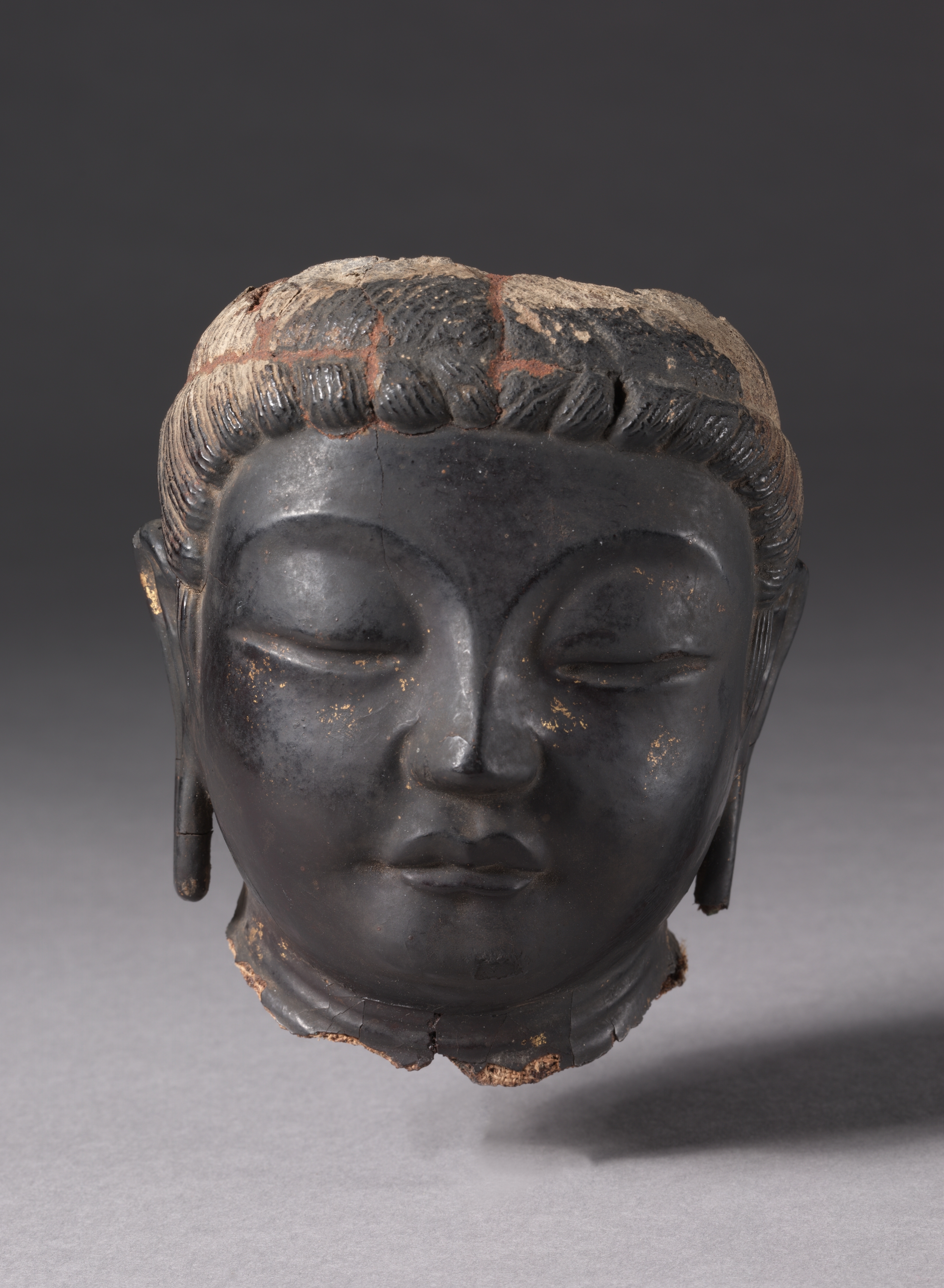 Nara dry-lacquer (kanshitsu) bodhisattva head, 700s, 13.7 cm. Cleanly broken at neck and crown; downcast eyes, full cheeks, traces of gilding on dark lacquer.