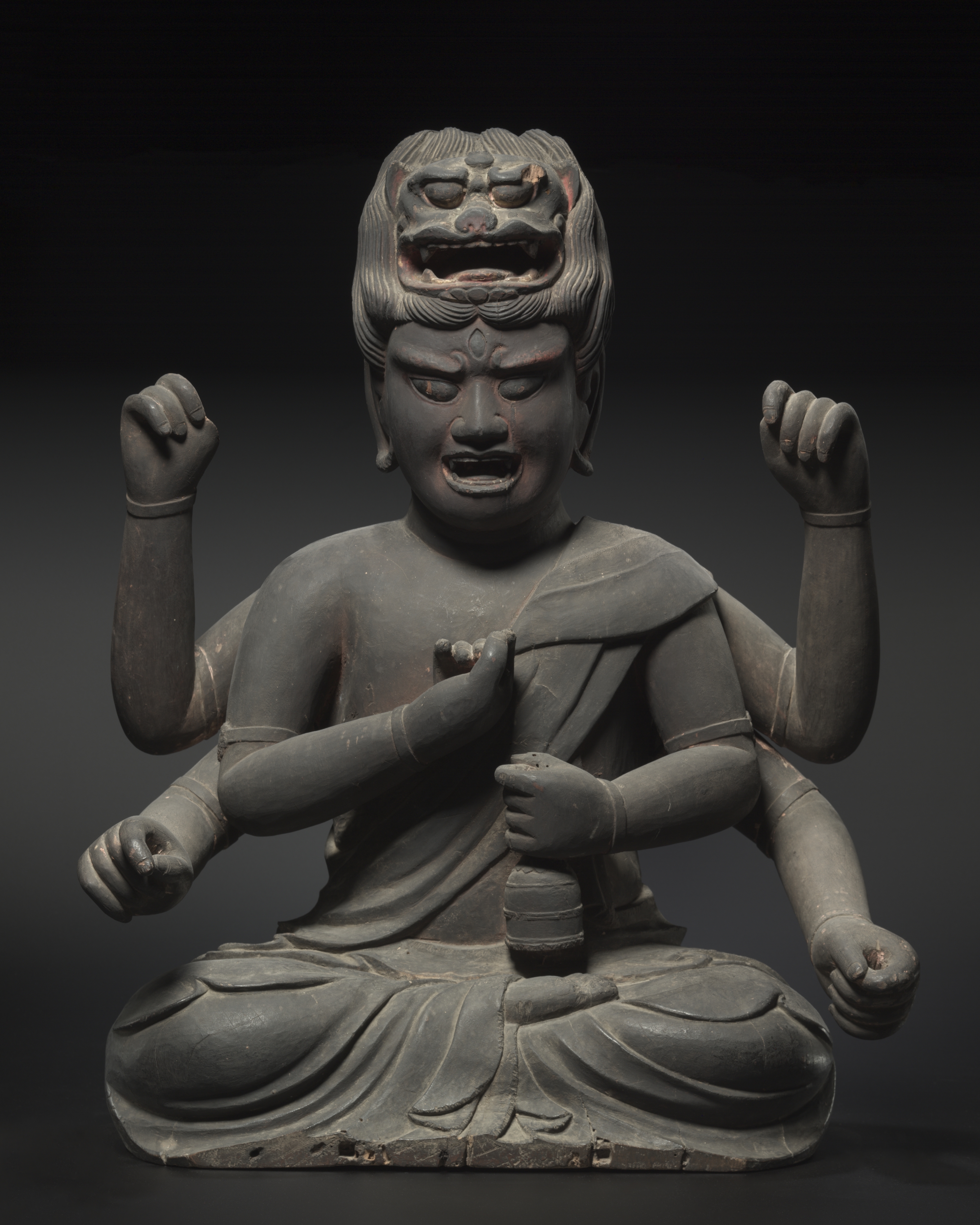 Kamakura six-armed Aizen Myōō, wood with black lacquer and red pigment, early 1300s, 75 cm. Lion-head crown projecting from the topknot; six empty hands.