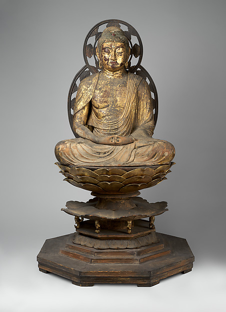 Kamakura standing wood Amida Buddha, c. 1250, 88 cm (155 cm with pedestal). Right hand raised, left lowered in raigō-in mudra; carved multi-tier lotus base.