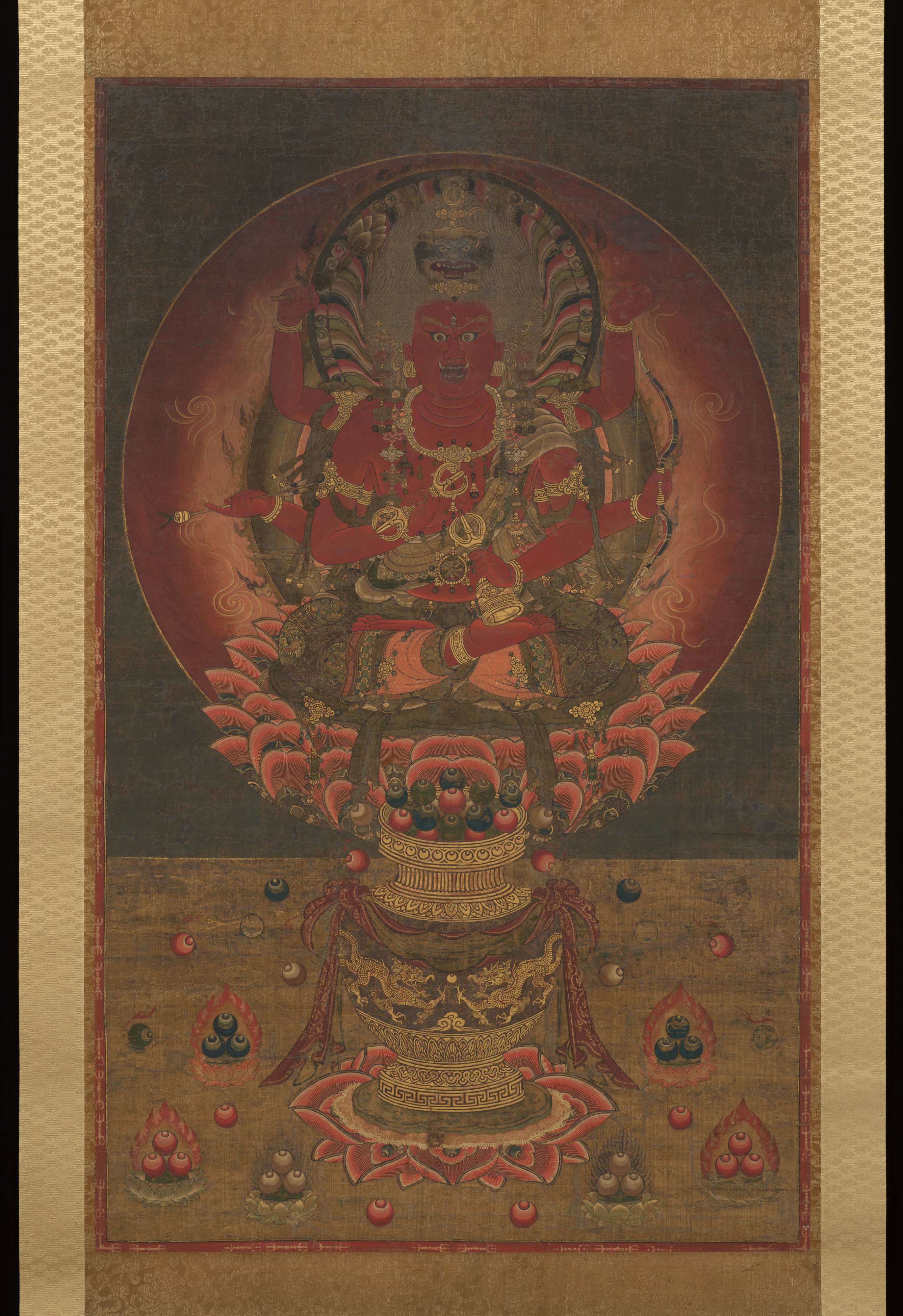 Nanbokuchō 14th-c. hanging scroll, colour gold and kirikane on silk, 135 × 82 cm. Six-armed red Aizen Myōō on a vase-supported lotus throne; lion crown; three eyes.