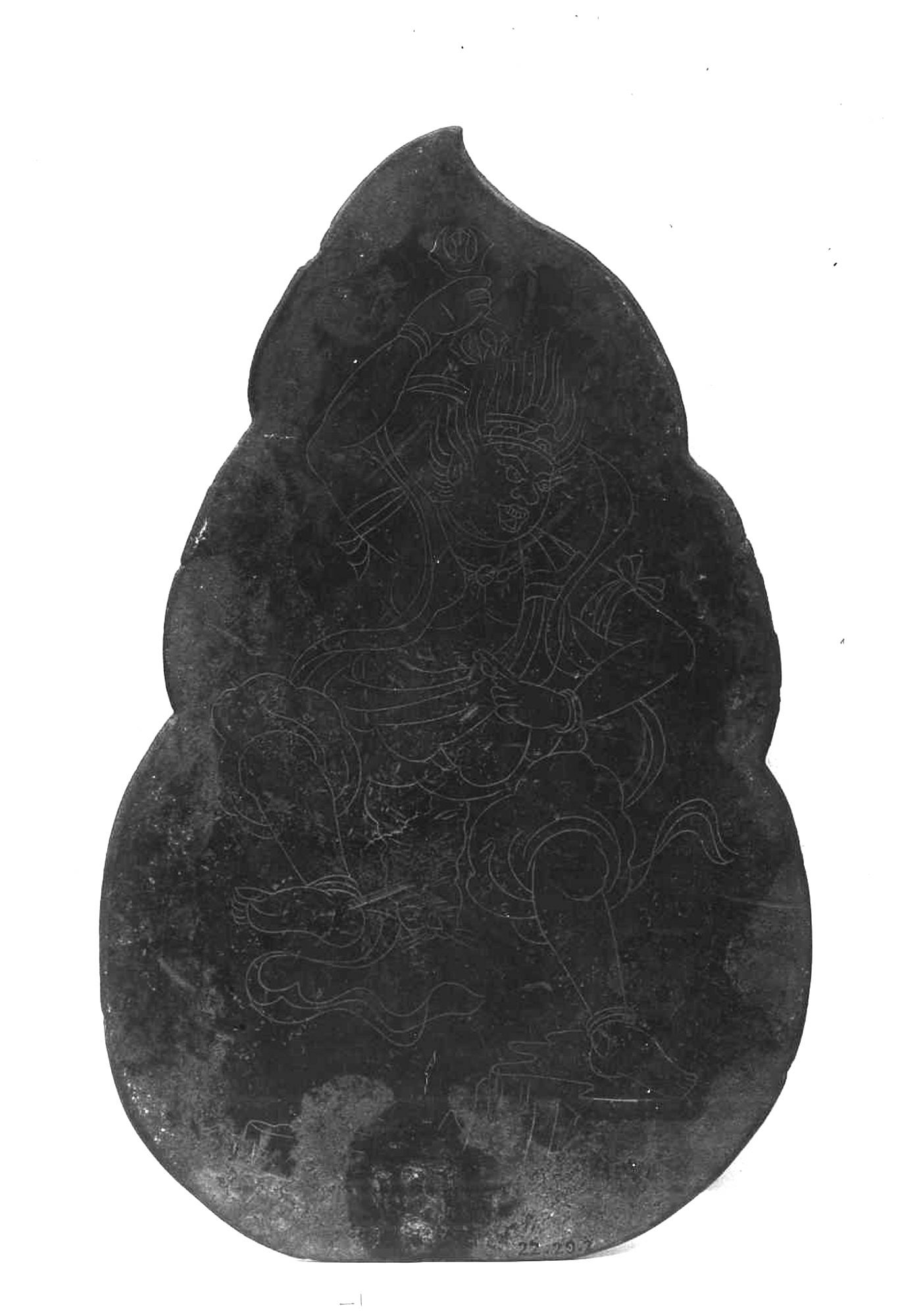 Incised Heian bronze plaque, 21.6 cm tall, flame-shaped, metal darkened and pitted. Zaō Gongen on a rocky outcrop, right foot raised, three-pronged vajra in the raised right hand.