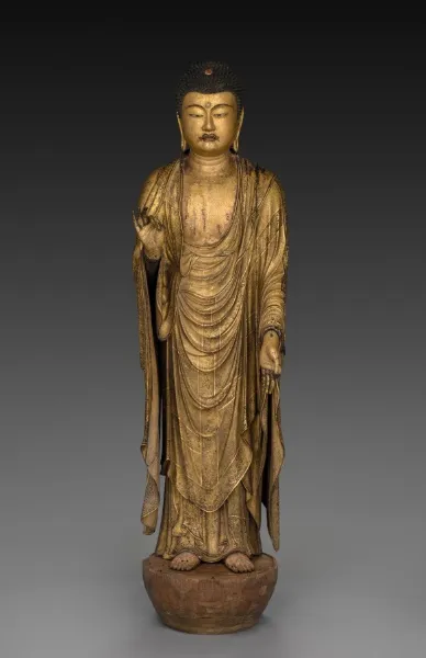 Kamakura standing Amida in gilt wood, 1269, 94.6 cm. Right hand raised, left lowered in raigō-in welcoming mudra; plain dark-wood lotus base.