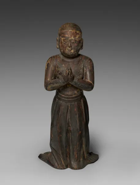 Kamakura early-1300s standing wood Shōtoku Taishi as a two-year-old, 69 cm, with rock-crystal eyes. Bare-chested in a long pleated skirt; palms in gasshō.