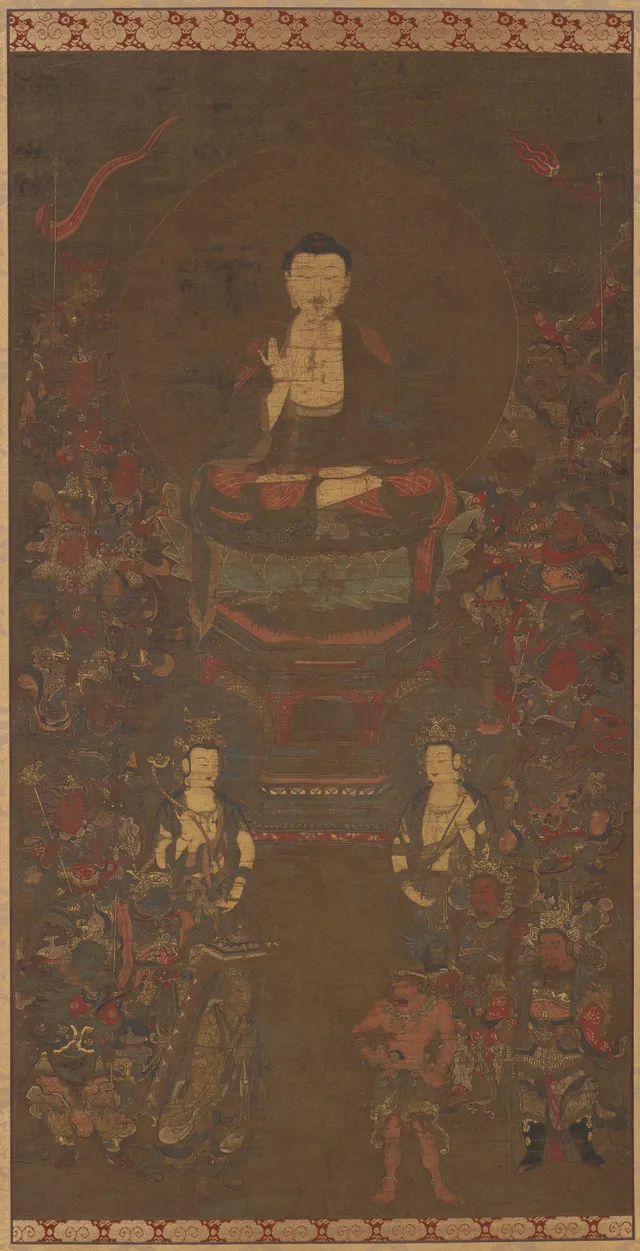 Hanging scroll, ink colour gold and cut gold on silk, 106 cm tall. A seated Buddha on a lotus throne flanked by two bodhisattvas, the three figures ringed by sixteen small armored