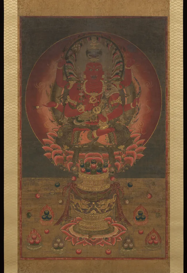 Nanbokuchō 14th-c. hanging scroll, colour gold and kirikane on silk, 135 × 82 cm. Six-armed red Aizen Myōō on a vase-supported lotus throne; lion crown; three eyes.