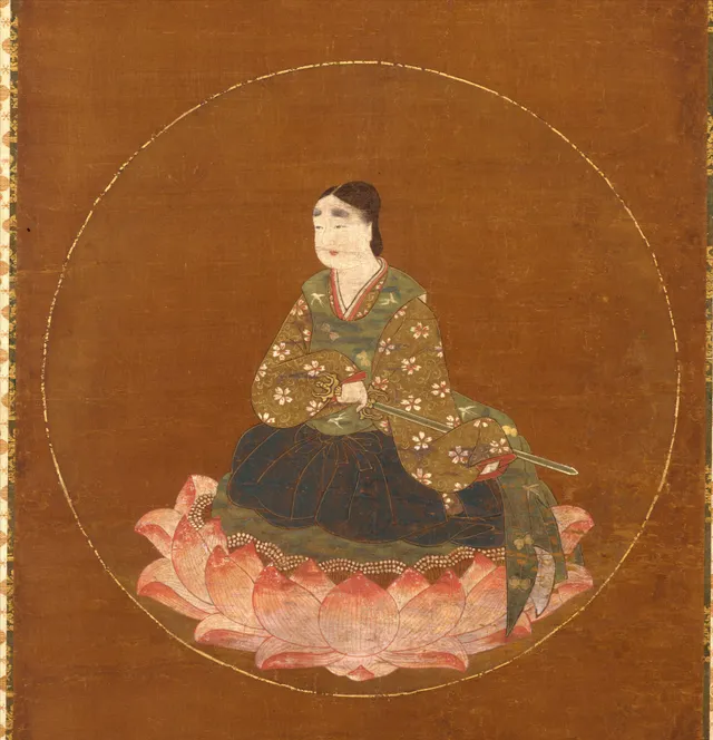 Hanging scroll, ink colour gold and cut gold on silk, 75.6 × 38.1 cm. A youthful courtly figure in white robes sits on a lotus within a gold disc above a shrine compound at a